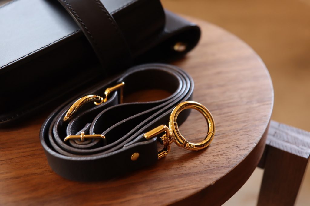 Belt with glossy custom hardware